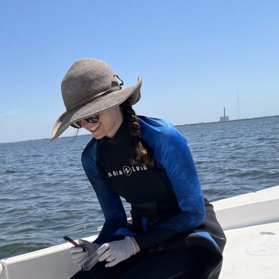 Elise Morrison doing field work on a boat